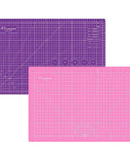 Front view of pink 18x12 inch self-healing cutting mat, double-sided, with purple A3 mat behind.