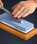 Using Premium Knife Sharpening Stone Whetstone 1000 6000 Grit with Non Slip Base for sharpening a tool by hand