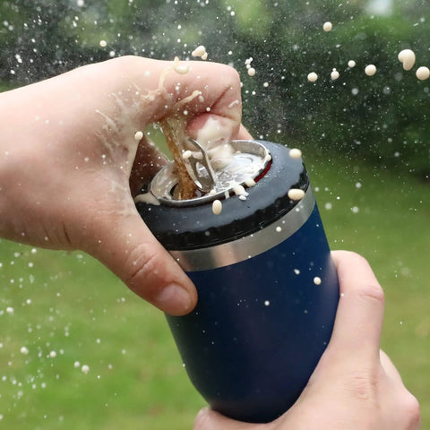 Hella Tough Navy Blue Four In One Insulated Stainless Steel Drink Koozie opening 12 oz can, spilling beverage.