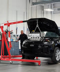 2 Ton Foldable Engine Hoist Cherry Picker lifting car engine in garage setting