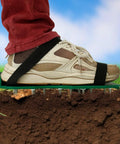 Person wearing spike shoes on turf, part of 2 Pack Spiked Roller for Self Leveling Floors Multipurpose Cement and Epoxy Floor Tool Set