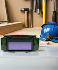 No Sweat Auto Darkening Welding Goggles With Impact Resistant Lens And Heavy Duty Debris Shield Eye Protection Built Tough, shown on workspace.