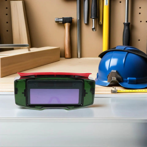 No Sweat Auto Darkening Welding Goggles With Impact Resistant Lens And Heavy Duty Debris Shield Eye Protection Built Tough, shown on workspace.