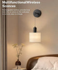 Cordless Battery Operated Wall Sconces Set Of 2 With Remote Control, mounted in bedroom, modern black fixture with beige shade.