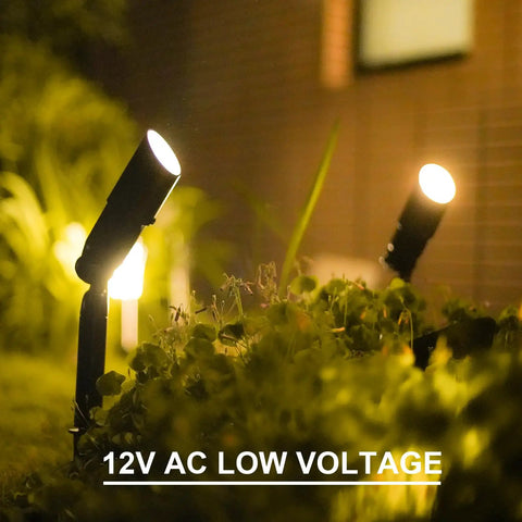 Low Voltage Landscape Spotlight Kit 8 Pack, 20W Halogen Outdoor Lights illuminating plants in garden