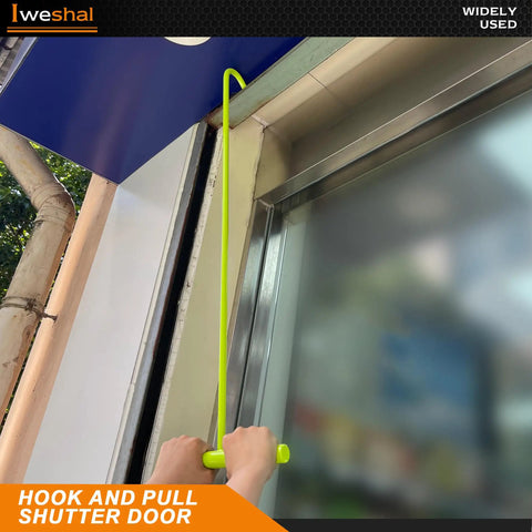 Person using hook to pull down a shutter door with Lieweshal hook tool.