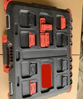 Black tool case with red and black heavy duty mounting feet for Packout system on cardboard surface.