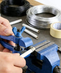 Heavy Duty Handheld Vise Pliers 50mm Mini Bench Clamp For DIY And Home Use, Cast Iron Body With Carbon Steel Jaws in action holding a white pipe.