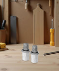 Four Pack Of Adjustable Stainless Steel Heavy Duty Furniture Legs With 2.8 To 3.6 Inch Height, Leveling Feet And Smooth Rotating Design For Workbenches, Metal Shelving, Desks, Cabinets, Wardrobes. Two stainless steel leveling feet on a workbench