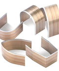 Curved wood pieces on a white background, showcasing the texture and finish of laminated wood strips.