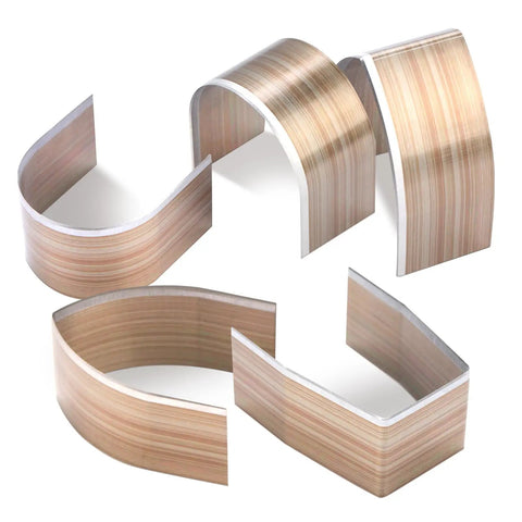 Curved wood pieces on a white background, showcasing the texture and finish of laminated wood strips.