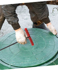 Heavy Duty Manhole Cover Lifter Hook Rock Solid Steel Build With Secure Comfort Handle and Slick T Shape Design For Quick Grate Drain Lid and Roller Shutter Access Without Any Fuss At All, being used on a green manhole cover.
