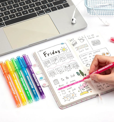 Six Pack Liquid Highlighters With Vibrant Assorted Colors And Clear View Design, Chisel Tip next to opened planner and laptop