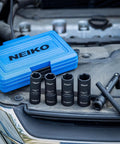 Half Size One Half Inch Impact Thin Wall Flip Lug Nut Socket Set With 5 Inch Extension Bar And Knockout Bar displayed on car engine