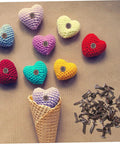Colorful crochet hearts with metal fasteners and brown brads beside them, suitable for 50 Pack Miniature Metal Fasteners and Close Pins for Scrapbooking Card Making and Craft DIY Brads Paper Fasteners for Arts and Crafts Projects and Creative Kid Friendly Activities Easy to Use.