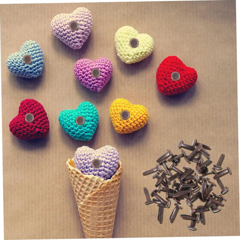 Colorful crochet hearts with metal fasteners and brown brads beside them, suitable for 50 Pack Miniature Metal Fasteners and Close Pins for Scrapbooking Card Making and Craft DIY Brads Paper Fasteners for Arts and Crafts Projects and Creative Kid Friendly Activities Easy to Use.