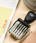 Everyday Kickass Six Digit Rubber Number Stamp Featuring Auto Rolling Dial For Quick Numbering Precise Date Stamping And Heavy Duty Office Project Grind on desk.