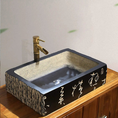 Kickstart Your Top Shelf Bathroom Refresh With This Retro Ceramic Vessel Sink Featuring Imitation Stone Finish And Including Faucet For Single Basin Above Counter Lavatory Vanity Setup. Black rectangular ceramic sink with golden faucet.