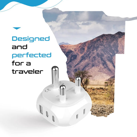 South Africa Travel Adapter With 5 In 1 Input And QC 3.1A Dual USB And USB C, Ultra Compact And Lightweight, White, Your Go To For US To Type M Outlets In Namibia, Botswana And More shown in front of a scenic landscape with mountains under a clear sky.