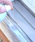 Person applying Silicone Lubricant With Teflon Fluoro Polymer For Non Metal Materials on a door track to reduce friction and sticking
