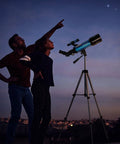 70mm Travel Astronomy Telescope With 400mm Focal Length And 70mm Aperture, K6 And K25 Eyepieces, 45 Degree Erect Diagonal, Adjustable Tripod, Phone Adapter, Great For Beginners And Stargazers on tripod with two people viewing stars
