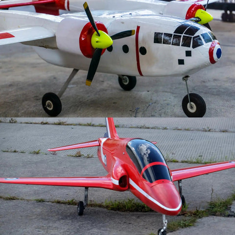 Close-up of RC airplane models on ground, showcasing the use of RC Airplane Landing Gear Drive Shaft Axle Kit Five Sixteenth Inch Diameter By Two Point Two Inch Length Four Pack With Nuts Built Tough For Remote Control Planes And Hobby Projects.