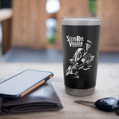 Artist Image Stainless Steel Insulated Tumbler With Dual Wall Insulation, Leak Proof Lid, BPA Free, Keeps Your Coffee Hot Or Ice Cold, Black Finish, Made For Road Trips And Everyday Grabs, Music Fan Approved displayed on table near phone and wallet
