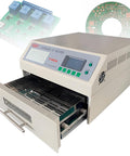 Automatic Reflow Soldering Oven With Infrared Heater And Hot Air Circulation For PCB Boards SMT SMD BGA Rework Station Model T962A shown with open tray and sample circuit boards