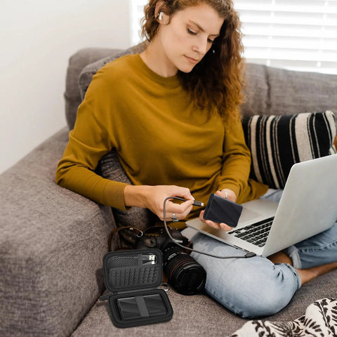Woman using laptop with Go To Portable SSD Case For T9 T7 T7 Shield And T7 Touch 1TB 2TB 4TB External Drives Travel Box nearby