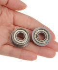 Two FR6ZZ Flanged Ball Bearings Three Eighths Inch By Seven Eighths Inch By Nine Thirty Seconds Inch in hand view.