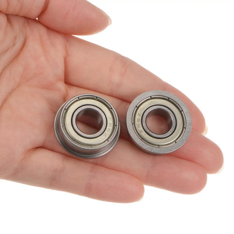 Two FR6ZZ Flanged Ball Bearings Three Eighths Inch By Seven Eighths Inch By Nine Thirty Seconds Inch in hand view.