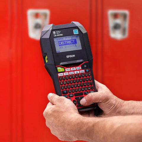 Commercial Heavy Duty Industrial Label Maker Kit Printing On Wide Heat Shrink Vinyl And Self Laminating Tape High Volume Rollback System Built Like A Tank For Daily Grind Jobs in use with visible screen and buttons.