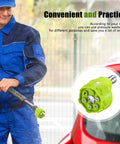 Front view of a man in blue workwear using green 2-pack 6-in-1 pressure washer nozzles with metal connector.