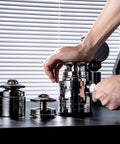 Upgrade Your Daily Grind With This Premium 58mm Espresso Accessories Kit in use, showcasing metal tampers on a countertop.