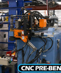 CNC pre-bending machine in industrial setting with control panel and hydraulic components visible
