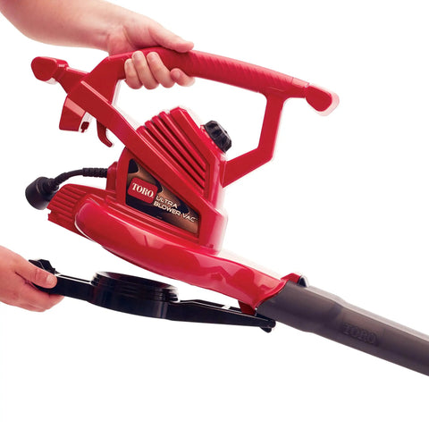 Red Ultra Electric Blower Vac With 250 MPH Airflow, metal impeller, shown being used held by hands, for yard cleanup with accessories