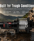Top Tier 4500Lbs Electric Winch With Heavy Duty Steel Cable And Wired Remote Control against a rugged outdoor backdrop.