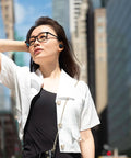 Person wearing Tune Buds True Wireless Earbuds With Noise Cancellation And Pure Bass Sound Bluetooth Five Point Three in urban setting.