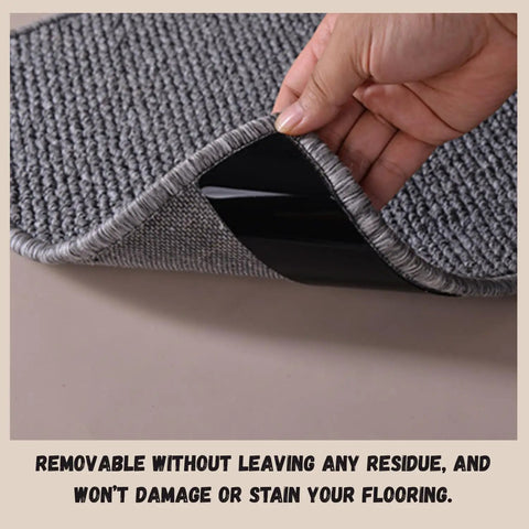 Hand lifting corner of rug to show 16 Pack Anti Slip Rug Tape Double Sided Carpet Grip For Hardwood Floors And Tiles Prevents Slipping Curling And Bunching On Area Rugs No Slip Pad That Stays Put.
