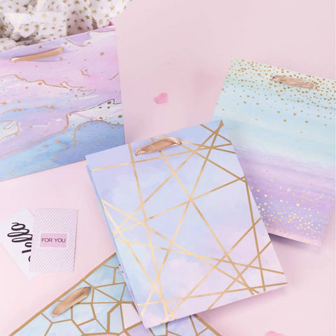 Colorful Marble Pattern Gift Bags With Tissue Paper And Gold Foil Accents, Medium Size 7x4x9 Inches, 4 Pack displayed on table