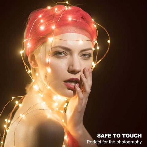 Model wrapped in Plug In Fairy Lights 33ft 100 LED Twinkle String Lights with Remote Timer 8 Modes for indoor decor