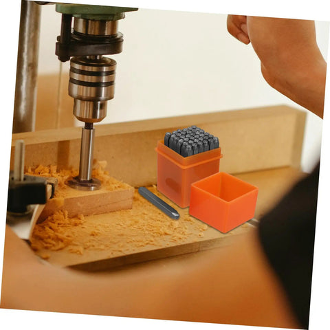 37 Piece Metal Stamping Kit With Letter And Number Punch Set Plus Heart Symbols on wooden workbench with drill