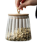 Level Up Your Kitchen With This Tough Clear Glass Storage Jar Boasting A Tight Airtight Wooden Lid Sealed Cap For Grains Coffee Beans Candy And Spices To Keep Everything Fresh On Hand, filled with dried flowers.