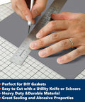 Person cutting Gray Silicone Rubber Sheet 12 Inch Wide One Eighth Inch Thick 12 Inch Long High Temperature Resistant Mat with ruler