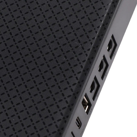 Close-up of Compact Mini Ups Backup Battery featuring USB and power ports on a textured black surface.
