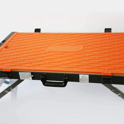 Close-up of an orange Four In One Portable Folding Workbench And Scaffold Platform with handle and metal frame, showing texture details.
