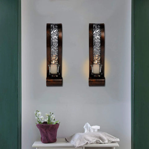 Upgrade Your Vibe With These Badass Antique Bronze Wall Sconces Featuring Openwork Glass Shade Tealight Holders on a wall with candles.