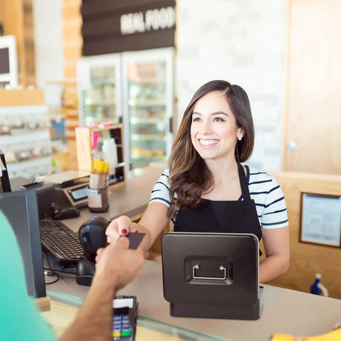Smiling cashier using Heavy Duty Metal Cash Box With Lock And Five Compartment Coin Tray, Built To Last Lockbox for cash