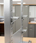 Heavy Hitter 18 Piece Silver Steel Shelf Clip Kit with clear view of adjustable brackets mounted on pilaster strips.