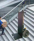 Heavy Duty Electric Stair Climbing Dolly With 1200W Motor lifting a box up stairs with telescoping handle in use.